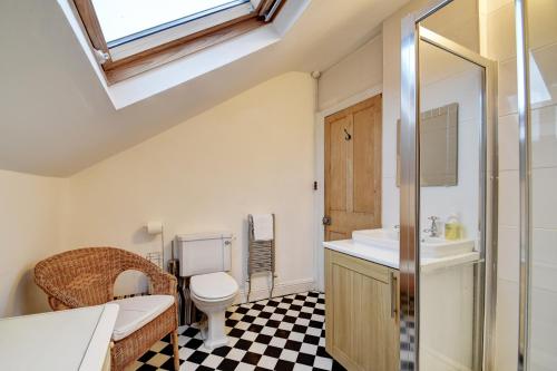 a bathroom with a sink toilet and a skylight at Spacious Victorian Townhouse near HCC with off street parking in Harrogate