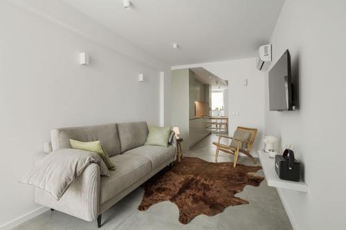 a living room with a couch and a rug at Lapa 84 - seafront house in Póvoa de Varzim
