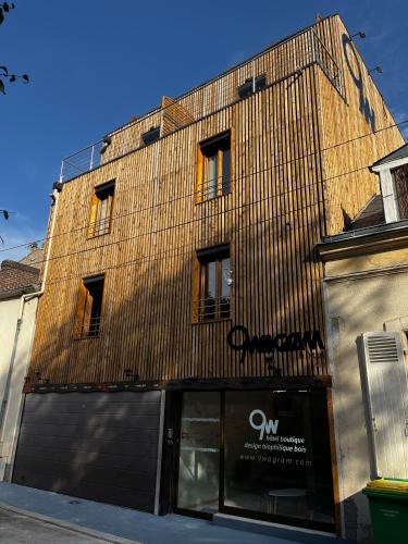 a building with a sign on the side of it at 9WAGRAM Hotel Boutique in Le Mans