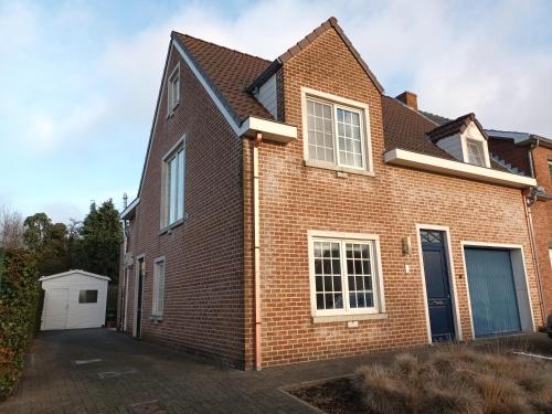 a brick house with a driveway at Kanaalzicht21 in Hasselt