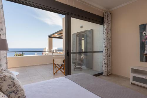 a bedroom with a view of the ocean at Aphaia Villa & Residences Aegina in Agia Marina Aegina