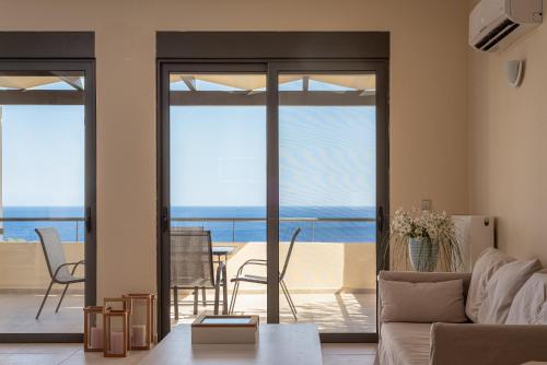 a living room with a view of the ocean at Aphaia Villa & Residences Aegina in Agia Marina Aegina