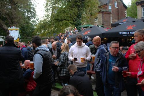 a large group of people standing around in a crowd at Hotel Anfield in Liverpool