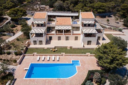 an aerial view of a mansion with a swimming pool at Aphaia Villa & Residences Aegina in Agia Marina Aegina