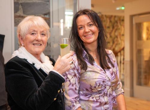 two women standing next to each other holding a drink at The Woodside in Doune