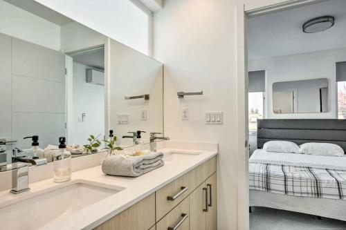 a white bathroom with a sink and a mirror at 4 Bed Modern Townhouse, WFH Office, Rooftop in Seattle