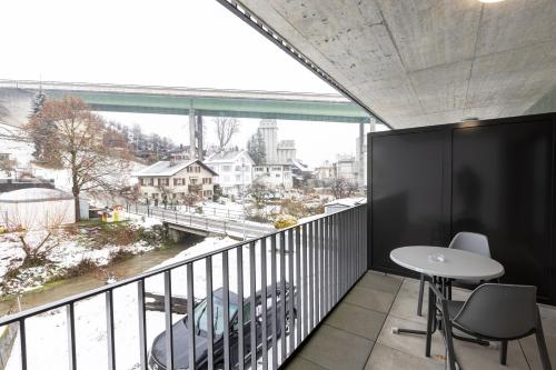 a balcony with a table and chairs and a view at Hotel Flamatt in Flamatt