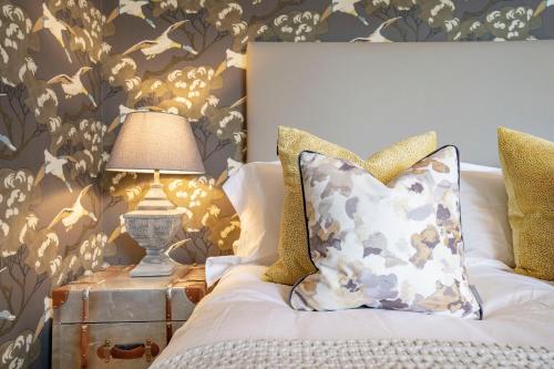 a bedroom with a bed with a lamp on a night stand at The Woodside in Doune