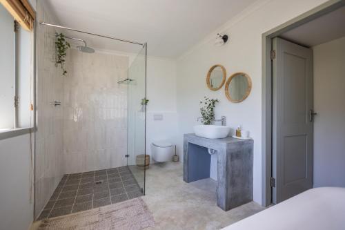 a bathroom with a sink and a shower at Ocean Mist in Plettenberg Bay