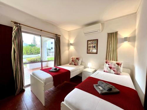 a hotel room with two beds and a window at Vilamoura Ocean Villa with Pool by Homing in Vilamoura