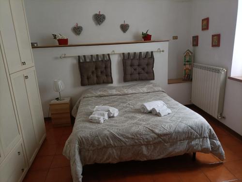 a bedroom with a bed with towels on it at Appartamenti Santa Chiara in Assisi