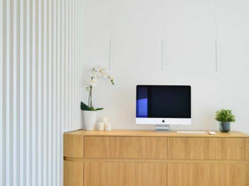 a computer monitor sitting on top of a wooden cabinet at Pascià Boutique Hotel in Ragalna