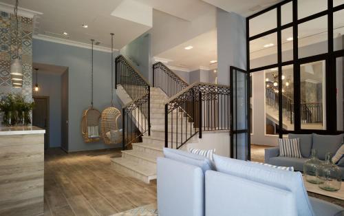 a living room with white furniture and a staircase at Hotel Boutique Balandret in Valencia