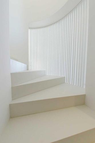 a staircase in a white room with a radiator at Pascià Boutique Hotel in Ragalna