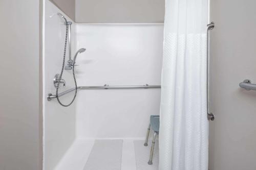 a bathroom with a shower with a shower curtain at Baymont by Wyndham Gurnee in Gurnee