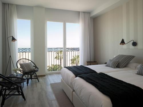 a bedroom with two beds and a view of the ocean at Hotel Boutique Balandret in Valencia