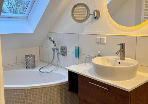 a bathroom with a sink and a bath tub at Hotel Resort Märkisches Meer in Diensdorf-Radlow