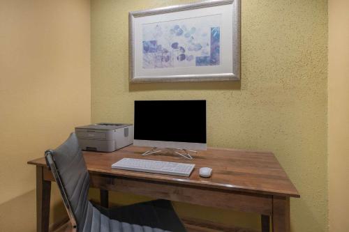 a desk with a computer and a printer on it at Baymont by Wyndham Gurnee in Gurnee