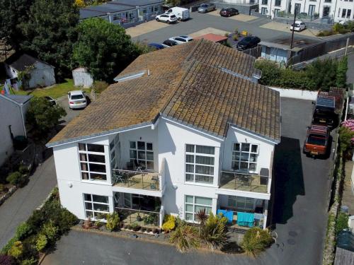 an aerial view of a white house with a roof at Pass the Keys 2 Bed Sea View Apartment with Balcony Parking in Benllech