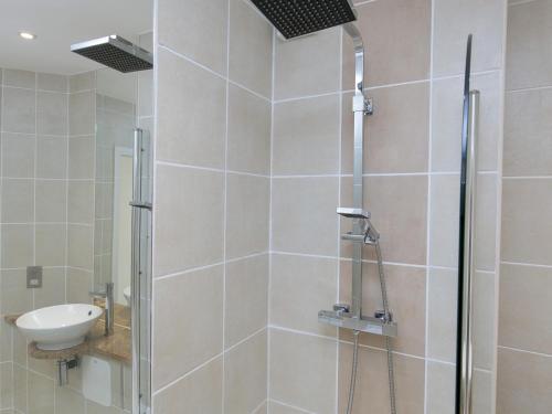 a bathroom with a shower and a sink at Pass the Keys 2 Bed Sea View Apartment with Balcony Parking in Benllech