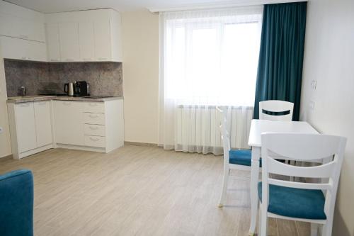 a kitchen with a table and chairs in a room at Роял Шумен in Shumen