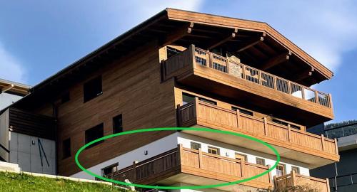 a building with a green circle in front of it at Alpenliebe Zillertal in Hart im Zillertal