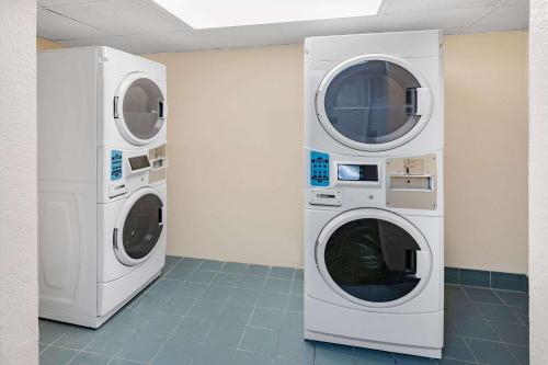 two washing machines in a room next to each other at Days Inn by Wyndham Del Rio in Del Rio