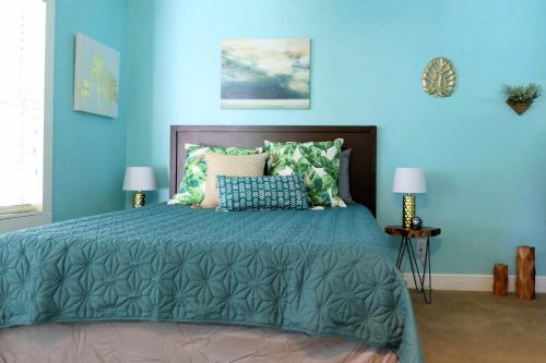 a bedroom with a large bed with blue walls at Barra Villa Resort House II in Fort Myers