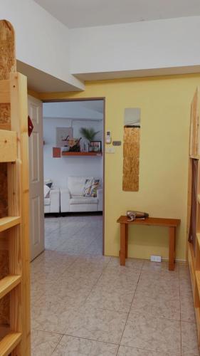 a living room with a table and a couch at South Talk B&B in Hengchun