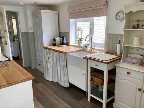 a kitchen with a sink and a counter top at Traditional Cottage in West Kilbride Village in Seamill