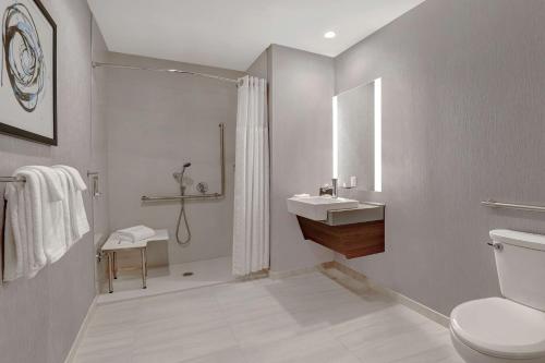 a bathroom with a toilet and a sink and a shower at Hyatt Place Ottawa West in Ottawa