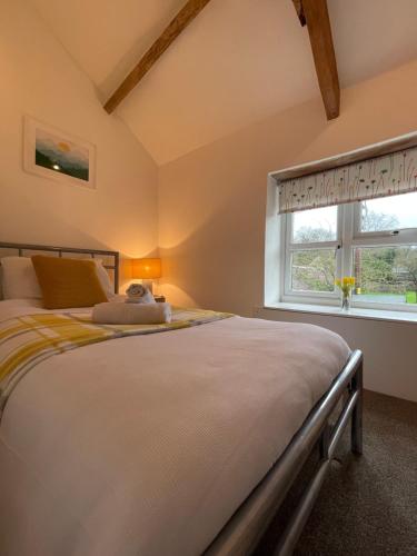 a bedroom with a bed and a window at Idyllic country cottage near Wells in Wells