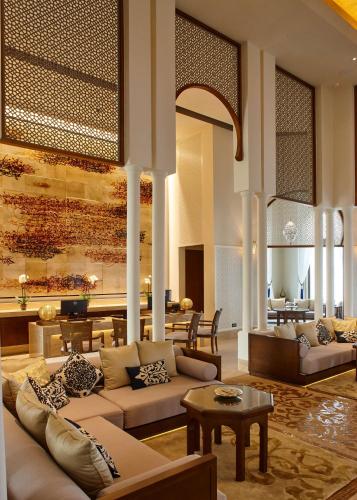 a living room with two couches and a table at Banyan Tree Tamouda Bay in Fnidek