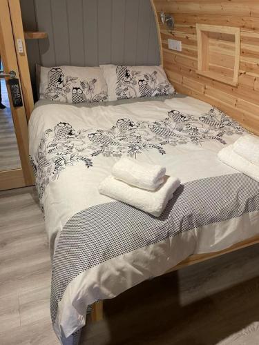a bed with two towels sitting on top of it at Glamping Pods in Milngavie