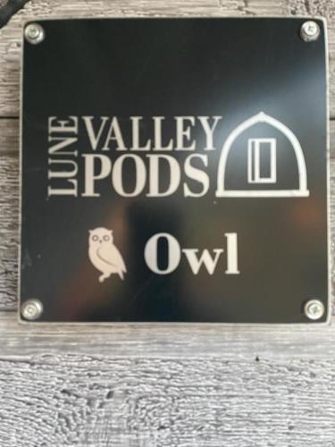 a sign for avalleyrods owl on a building at Glamping Pods in Milngavie