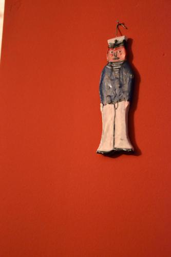 a christmas ornament hanging on a red wall at Bettstatt-Neustadt in Luzern