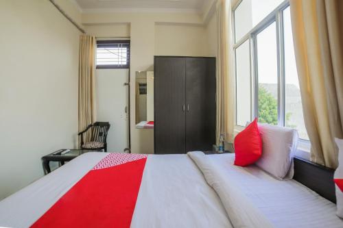 1 dormitorio con 1 cama grande con almohadas rojas y blancas en Hotel Tiger Regency Resort en Sawāi Mādhopur