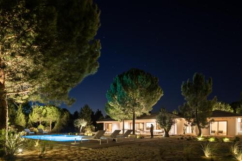 a villa with a pool at night at Spatia Comporta in Comporta