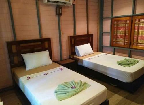 two beds sitting in a room at P P Garden Home Bungalow in Phi Phi Don