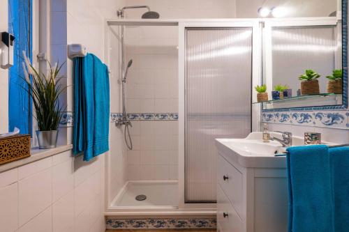 a bathroom with a shower and a sink at Villa Oasis Galé - Luxury Villa with private pool, AC, free wifi, 5 min from the beach in Albufeira