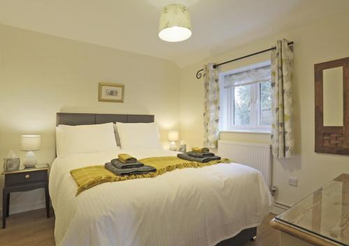 a bedroom with a bed with two towels on it at The Annexe in Snape