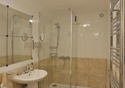a bathroom with a glass shower and a sink at The Annexe in Snape