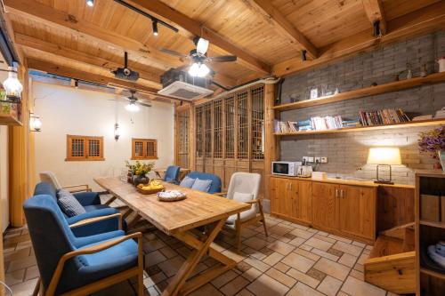 a kitchen and dining room with a wooden table and chairs at Mild Spring Boutique Hotel in Huangshan