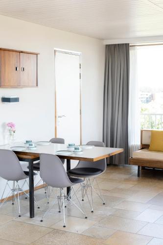 a dining room with a table and chairs at Hotel de Milliano in Breskens