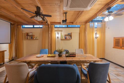 a dining room with a large wooden table and chairs at Mild Spring Boutique Hotel in Huangshan