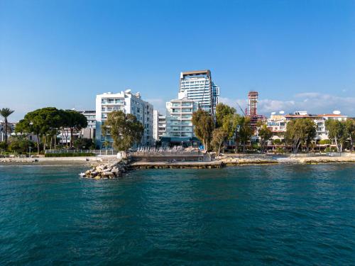 a body of water with a city in the background at Harmony Bay Hotel in Limassol