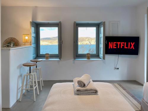 a hotel room with a bed and a sign that reads netflix at Bohemian Blue Villa - 7 BDRM - beach in 200m - MG Villas in Panormos Mykonos