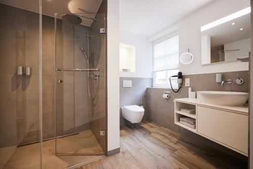 a bathroom with a shower and a sink and a toilet at Mühlenhelle in Gummersbach