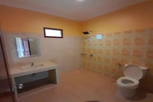 a bathroom with a toilet and a sink at EXPRESS O 91923 Homestay Zona in Sukabumi