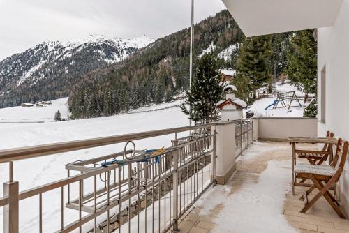 a balcony with a view of the snow covered mountains at Huterhof Apt Tatschblick in Riobianco